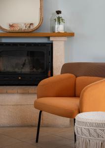 a living room with a couch and a fireplace at Katrin Aegina in Egina