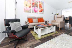a living room with a couch and a table at Ferienhaus Krosse Krabbe in Bensersiel +34 photos