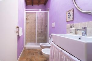 Baño púrpura con aseo y lavamanos en White Room, en Empoli