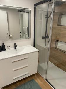 a bathroom with a white sink and a shower at Mirador de Telera - Precioso apartamento en el pueblo con espectaculares vistas in Panticosa +22 photos