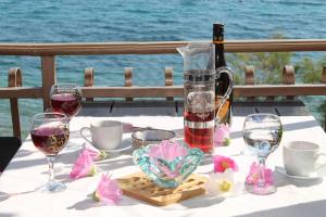 a table with a bottle of wine and glasses at Villa Aurelia Vodice in Vodice