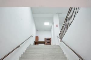 a staircase in an office building with white stairs at Square Inn in Gyumri