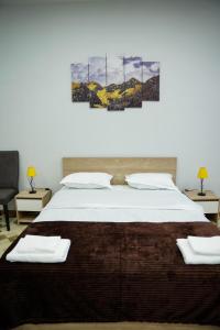 - une chambre avec un grand lit et 2 tables dans l'établissement Square Inn, à Gyumri