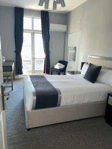 a bedroom with a large bed and a window at The Royal Hotel - Clacton On Sea in Clacton-on-Sea +30 photos