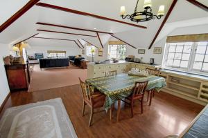 a kitchen and dining room with a table and chairs at Vale View Apartment in Porlock