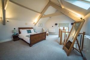 a bedroom with a bed in a attic at The Cowshed in Clatworthy