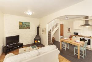 a living room with a white couch and a table at Worthy Cottage in Porlock