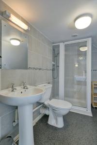 a bathroom with a sink and a toilet and a shower at Yenworthy Cottage in Culbone