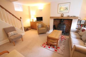 a living room with a couch and a fireplace at Magnolia Cottage in Porlock