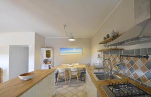 a kitchen with a table and a dining room at Sagittarius 1 in Marciana Marina