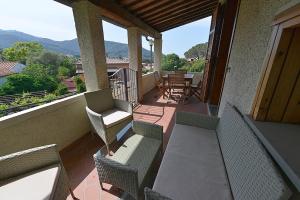 a balcony with a table and chairs on a balcony at Sagittarius 1 in Marciana Marina