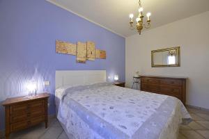a bedroom with a large bed and two night stands at Sagittarius 1 in Marciana Marina