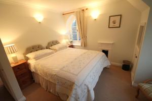 a bedroom with a large bed and a window at Dunkery Apartment in Porlock
