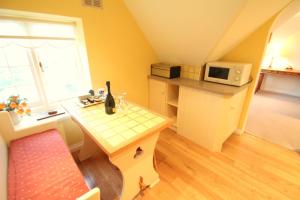 a small kitchen with a table and a microwave at Dunkery Apartment in Porlock