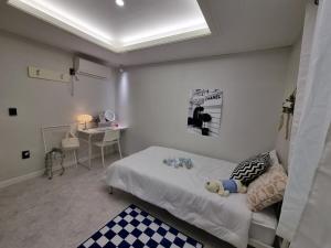 a bedroom with a bed and a desk in it at Urban Stay Anyang in Anyang