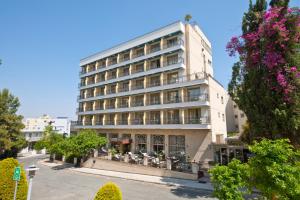 a building with tables and chairs in front of it at Semeli Hotel in Nicosia
