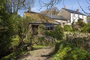 an old house with ivy on the side of it at The Shippon in Wheddon Cross