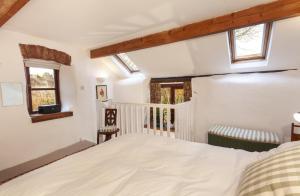 Tempat tidur dalam kamar di Garden Cottage, Wiveliscombe