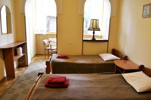 a room with two beds and two windows at Malvy hotel in Truskavets