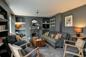 a living room with two couches and a table at 48 Swain Street, Watchet in Watchet