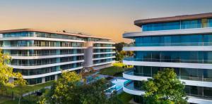 an aerial view of a large building with trees at Wave Luxury Apartment in Siófok