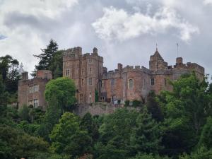 an old castle sitting on top of a hill at The Dog House, Porlock in Porlock