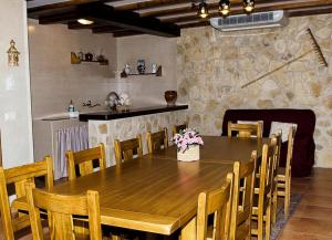 a dining room with a wooden table and chairs at Casa Rural Paula in Zarzuela del Monte