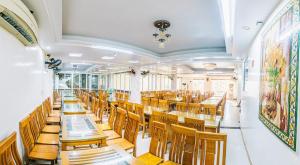 a dining room with wooden tables and chairs at Khách sạn Chinh Thuỷ in Sầm Sơn