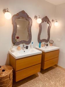 La salle de bains est pourvue de 2 lavabos et de 2 miroirs. dans l'établissement Maison d'Hôtes " L'INSTANT D'AILLEURS", à Albi