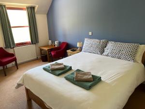 sypialnia z dużym łóżkiem z 2 poduszkami w obiekcie Lochailort Inn w mieście Lochailort