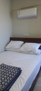 a bedroom with a bed with white sheets and pillows at Princess resort unit number 260A Markos in Hurghada