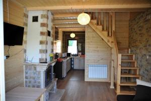 a small kitchen with a staircase in a tiny house at Całoroczne Domki Aga in Hoczew