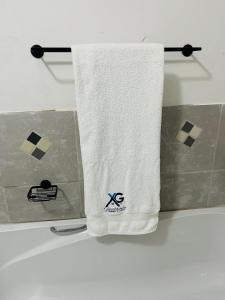 a white towel hanging on a towel rack in a bathroom at XG Guesthouse in Barkly East
