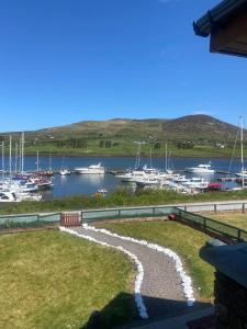 a view of a marina with boats in the water at Picturesque Riverside Home in Cahersiveen