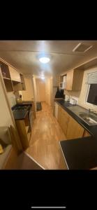 a small kitchen with a sink and a counter top at Static Caravan Marine Holiday Park in Rhyl