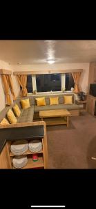 a living room with a couch and a table at Static Caravan Marine Holiday Park in Rhyl