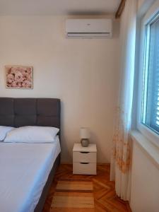 Łóżko lub łóżka w pokoju w obiekcie Buena Vida Apartman