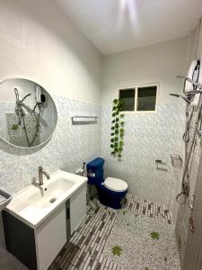 a bathroom with a sink and a toilet and a mirror at H&Q Bangtao Kitchen Studio in Bang Tao Beach