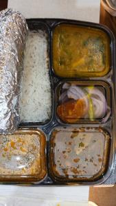a plastic container filled with different types of food at Anaya Guest House Etah in Etah