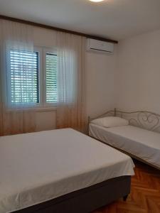 Łóżko lub łóżka w pokoju w obiekcie Buena Vida Apartman