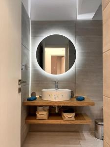 a bathroom with a sink and a mirror at Endless Bleu Villa Andros Island in Apróvaton