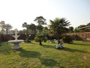 a park with a fountain in the grass at Maison Tournebride in Meillac