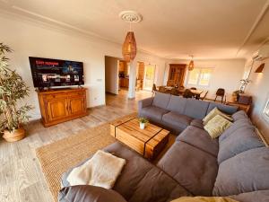 a living room with a couch and a tv at Denia Dream Seaview Golf, Tennis & Beach Villa in Muntanya la Sella
