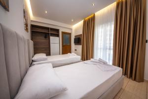 Postel nebo postele na pokoji v ubytování Hotel New Crystal