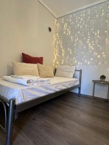 a bed in a room with lights on the wall at 7PocketHouse in Thessaloniki