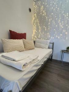 a bedroom with a bed with lights on the wall at 7PocketHouse in Thessaloniki