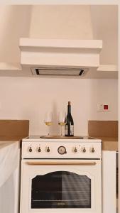 two glasses of wine sitting on top of an oven at Traditional suites in Chora Kythnos #7 in Kithnos