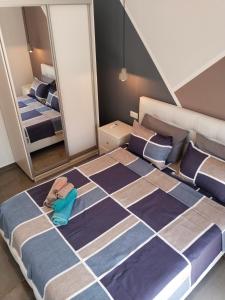 a large bed in a room with two mirrors at Theasis 2 in Neos Marmaras