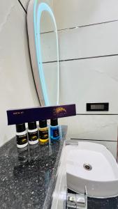 a bathroom counter with a sink and a mirror at The Vacation Villa in Agra