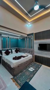 a bedroom with a large bed and a television at The Vacation Villa in Agra
